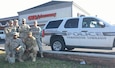 A group of U.S. Army Reserve military police Soldiers from the 372nd Military Police Company, of Cumberland, Md., pose in front of a pharmacy in Pemberton Township, N.J., after stopping an armed robbery that took place Dec. 12. (Courtesy photo)