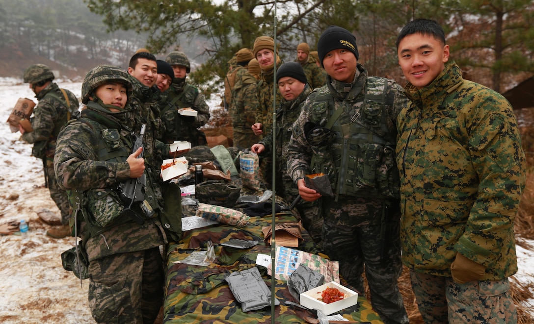 Marines share MRE’s with Republic of Korea Marines at Rodriguez Live Fire Complex, South Korea, Dec. 21, 2015. Both Marines Corps will be training together and spending the holidays with each other. The Korean Marine Exchange Program is carried out in the spirit of the Republic of Korea-U.S. Mutual Defense Treaty signed between the two nations Oct. 1, 1953. The time spent together illustrates the enduring alliance and friendship between the ROK and U.S. The KMEP 16-3 focuses on the two countries’ combined commitment to the defense of the ROK and our shared, faithful commitment to peace and security in the region. The Marines are from 1st Battalion, 2nd Marines Regiment, currently forward deployed in the Pacific as part of 4th Marine Regiment, 3rd Marine Division, III Marine Expeditionary Force. (U.S. Marine Corps Photo by Lance Cpl. Jorge A. Rosales/Released)