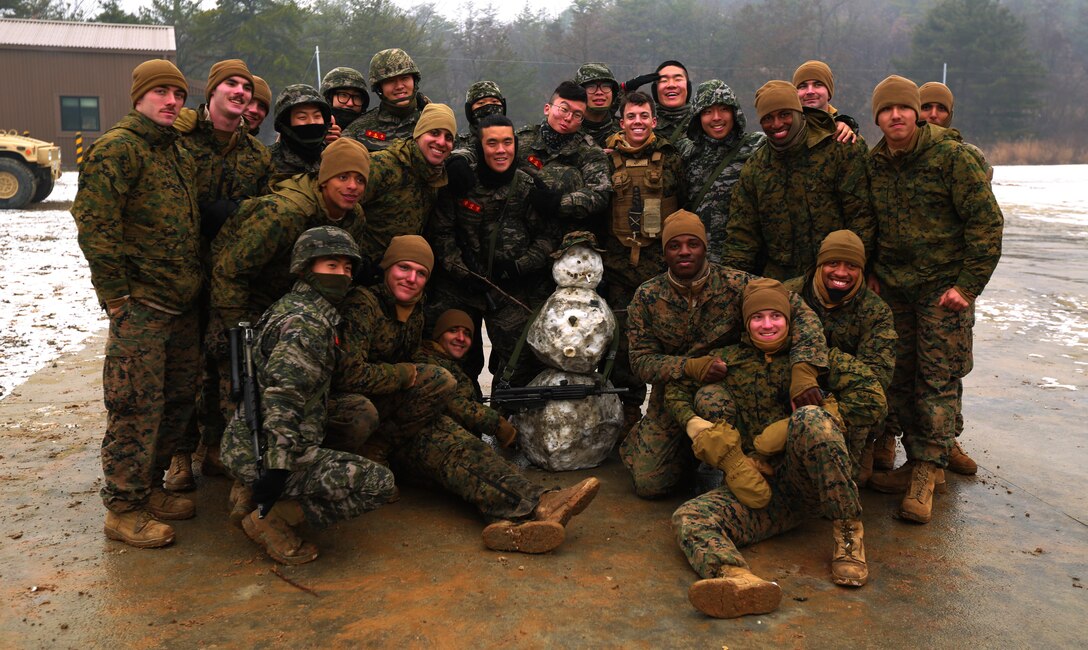 ROK and U.S. Marines pose with a snowman creatively constructed by both corps at Rodriguez Live Fire Complex, South Korea, Dec. 21, 2015. Both Marine Corps will be training together and spending the holidays with each other in the ROK. The Korean Marine Exchange Program is carried out in the spirit of the Republic of Korea-U.S. Mutual Defense Treaty signed between the two nations Oct. 1, 1953. The exercise illustrates the enduring alliance and friendship between the ROK and U.S. The KMEP 16-3 focuses on the two countries’ combined commitment to the defense of the ROK and our shared, faithful commitment to peace and security in the region. The Marines are from 1st Battalion, 2nd Marines regiment, currently deployed in the Pacific as part of 4th Marine Regiment, 3rd Marine Division, III Marine Expeditionary Force. (U.S. Marine Corps Photo by Lance Cpl. Jorge A. Rosales/Released)