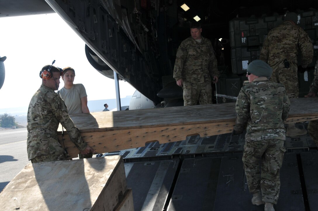 U.S. soldiers offload cargo from a C-17 Globemaster aircraft on Al Udeid Air Base, Qatar, Dec. 13, 2015. The soldiers, assigned to the 3rd Squadron, 6th Cavalry Regiment, offload cargo from AH-64 Apache helicopters. U.S. Air Force photo by Tech. Sgt. Terrica Y. Jones