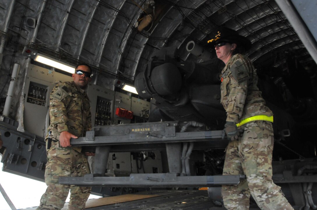 U.S. soldiers offload cargo from a C-17 Globemaster aircraft on Al Udeid Air Base, Qatar, Dec. 13, 2015. U.S. Air Force photo by Tech. Sgt. Terrica Y. Jones