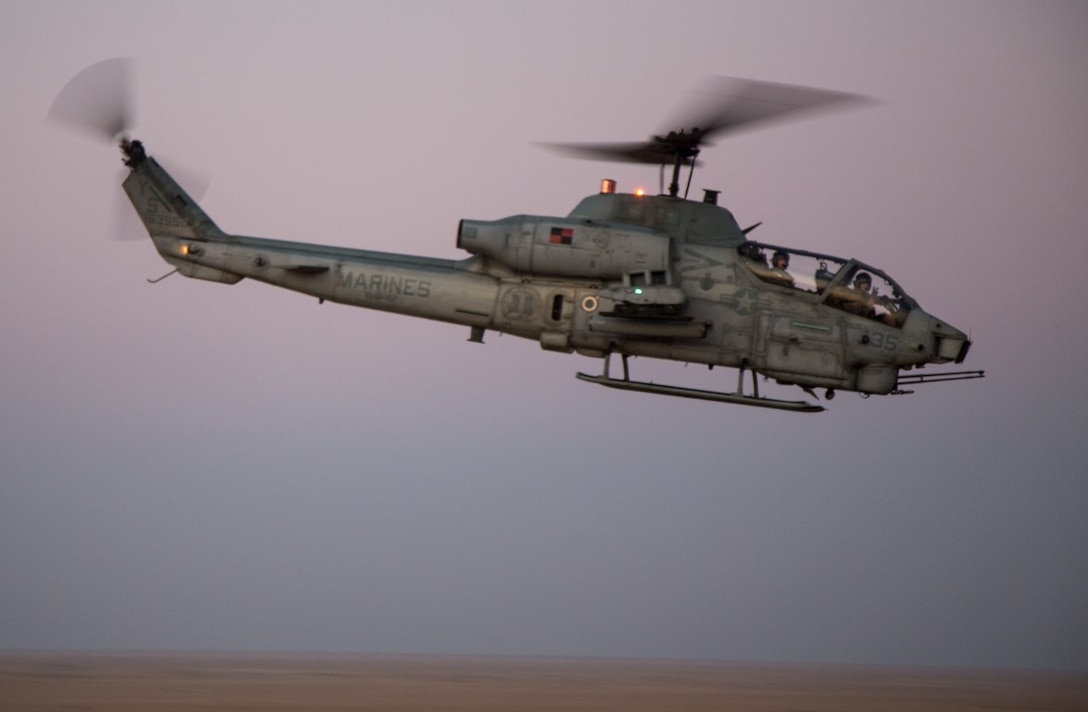 A U.S. Marine Corps AH-1W, Super Cobra, aircraft assigned to Marine Medium Tiltrotor Squadron 162 (Reinforced), 26th Marine Expeditionary Unit, flies over a live-fire range in support of a Tactical Air Control Party (TACP) at an undisclosed location in Southwest Asia, Dec. 14, 2015. TACP is designed to enable live, virtual, and constructive training for units and allows participating services, to include the U.S. Army, to strengthen partnerships and their interoperability. (U.S. Marine Corps photograph by Staff Sgt. Nathan O. Sotelo/Released)