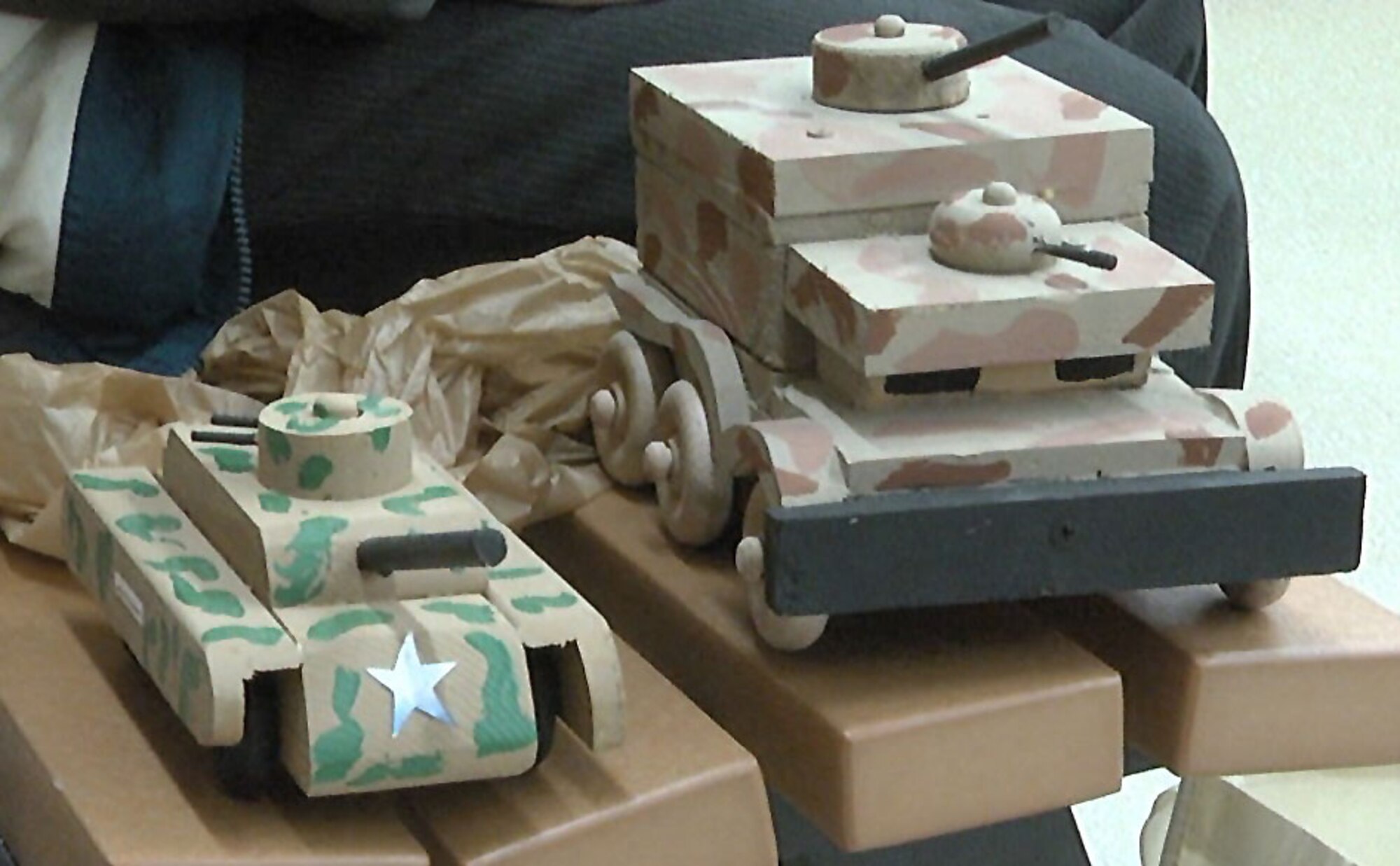 Harold Adams makes wooden toys like these tanks to give to children at the Sheppard Air Force Base commissary. (U.S. Air Force photo/Aliza Reisberg)
