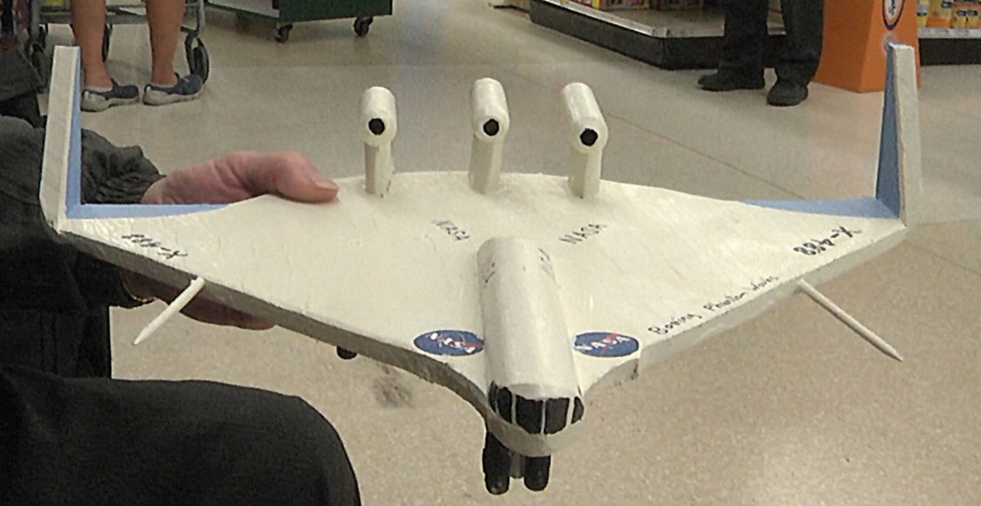 Harold Adams, retired Air Force mechanic, shows off his NASA aircraft toy Dec. 18, 2015, at the Sheppard Air Force Base commissary. The toy took two days to make. (U.S. Air Force photo/Aliza Reisberg)

