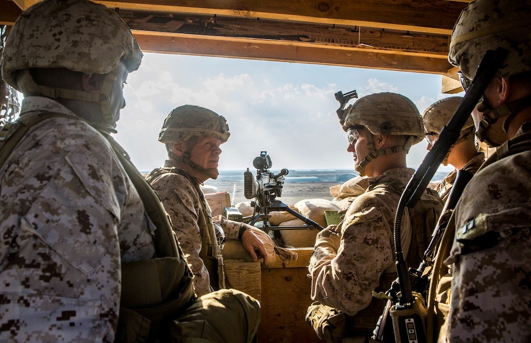 U.S. Marine Gen. Robert B. Neller, 37th commandant of the Marine Corps, and Sgt. Maj. Ronald Green, 18th Sergeant Major of the Marine Corps, visit Marines on post with 1st Battalion, 7th Marine Regiment, Special Purpose Marine Air Ground Task  Force - Crisis Response - Central Command at Al Asad Air Base, Iraq, Dec. 21, 2015. During their visit to the U.S. Central Command area of responsibility, the leaders addressed Marines and Sailors on matters concerning the future of the Corps and wished them all a merry Christmas. SPMAGTF-CR-CC is deployed with a crisis response mission spanning 20 nations of U.S. Central Command. (U.S. Marine Corps Photo by Sgt. Rick Hurtado / Released)