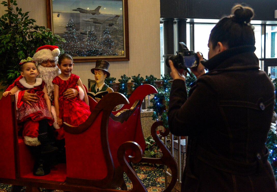 Lacey Ferrell, Osan spouse, photographs her children with Santa during the 51st Force Support Squadron’s “Brunch with Santa” on Osan Air Base, Republic of Korea, Dec. 20, 2015. Families enjoyed a holiday themed meal and children were able to meet and take photos with Santa. (U.S. Air Force photo/Senior Airman Kristin High)