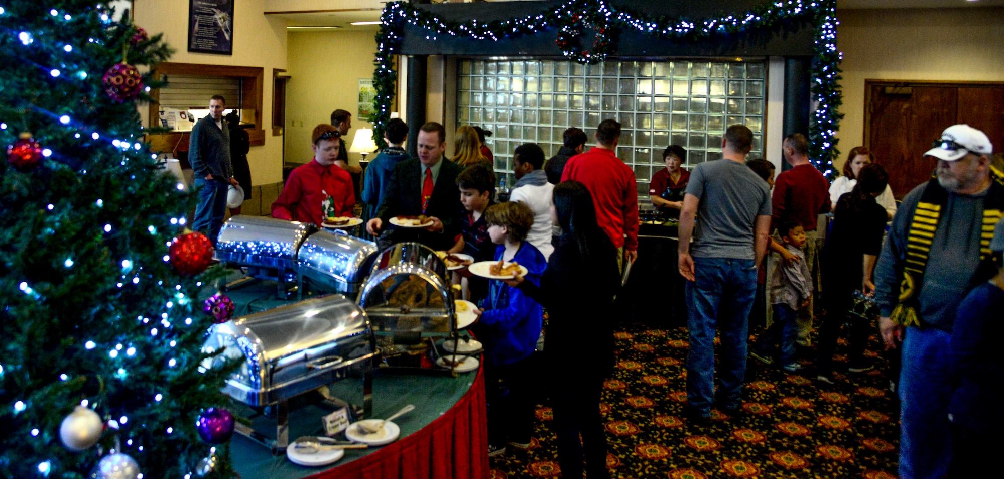 Members of Team Osan walk through the buffet line during the 51st Force Support Squadron’s “Brunch with Santa” on Osan Air Base, Republic of Korea, Dec. 20, 2015. The 51st FSS hosted the annual brunch with Santa which included a holiday turkey and ham with all of the fixings. More than 200 Team Osan members attended the annual holiday brunch at the Officer’s Club. (U.S. Air Force photo/Senior Airman Kristin High)