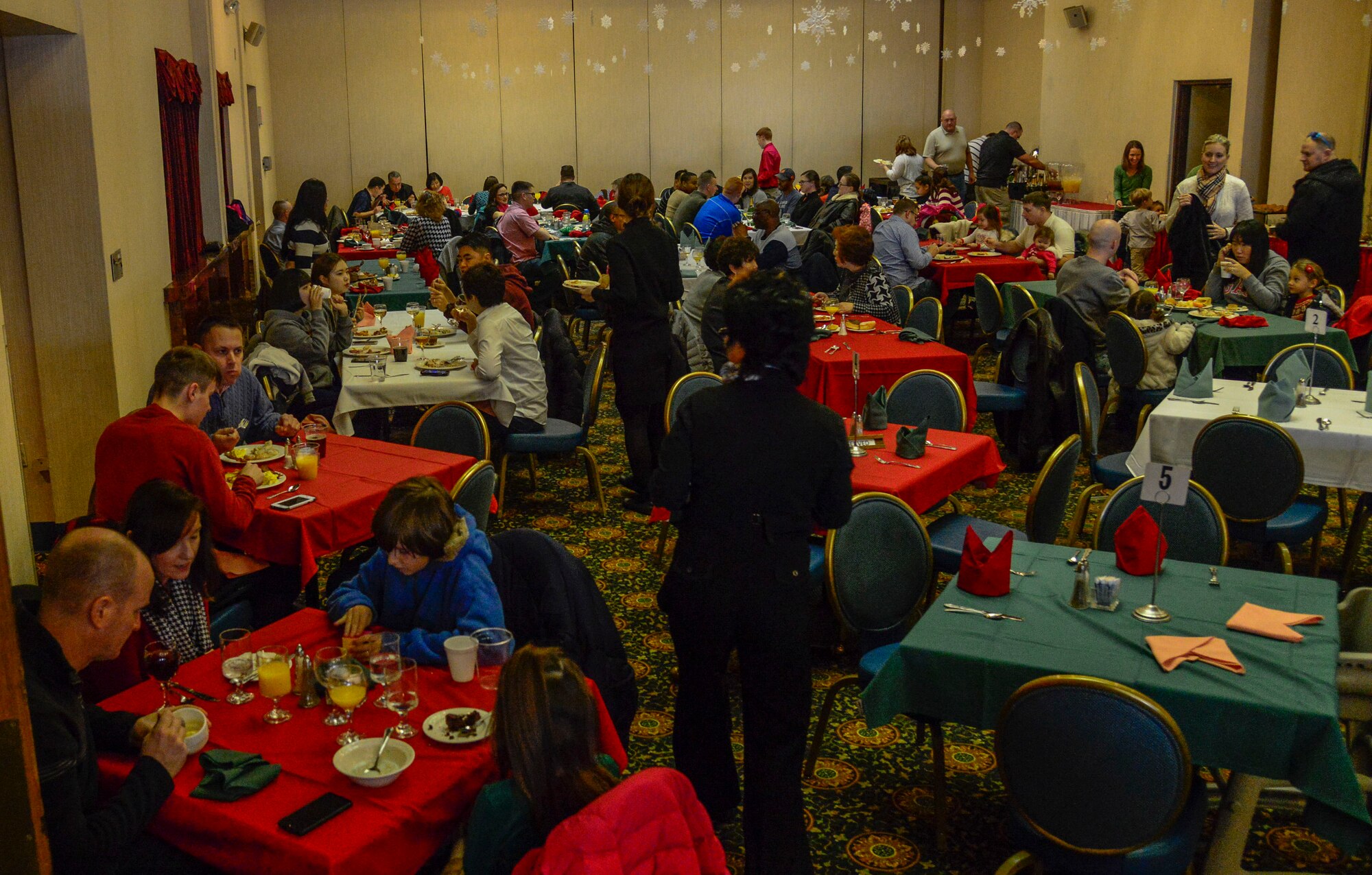 Team Osan members gather for the 51st Force Support Squadron’s “Brunch with Santa” on Osan Air Base, Republic of Korea, Dec. 20, 2015. Osan families feasted on holiday turkey and ham with fixings and met with Santa. More than 200 Airmen and family members attended the annual holiday brunch. (U.S. Air Force photo/Senior Airman Kristin High)

