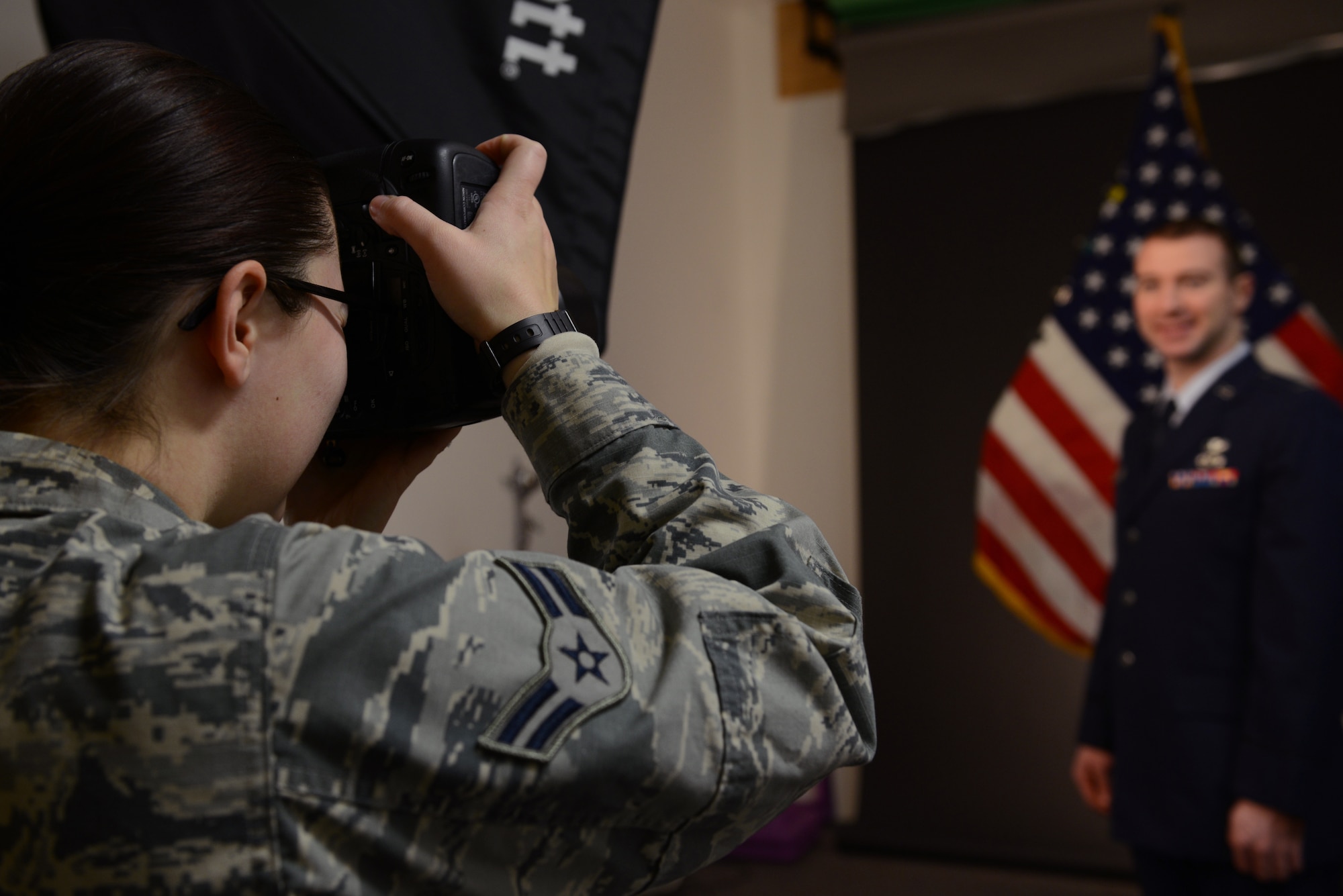 U.S. Air Force Airman 1st Class Cassandra Whitman, a 354th Fighter Wing public affairs photojournalist, takes a studio photo Dec. 22, 2015, at Eielson Air Force Base, Alaska. Whitman is approaching the one year mark in the Air Force and reflected on how her decision to join the military has positively affected her life. (U.S. Air Force photo by Senior Airman Ashley Nicole Taylor/Released)