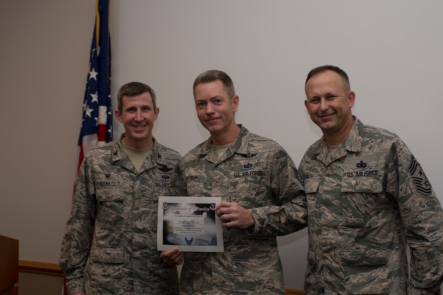U.S. Air Force Col. Thomas Kunkel, left, 23d Wing commander, and Chief Master Sgt. David Kelch, right, 23d WG command chief, pose for a photo with Staff Sgt. Joseph Pittman, 23d Contracting Squadron, after he was promoted under the Stripes for Exceptional Performers program, Dec. 23, 2015, at Moody Air Force Base, Ga. The 23d Wing leadership surprised Pittman at work and announced that he was being STEP promoted from staff sergeant to technical sergeant. (U.S. Air Force photo by Airman Daniel Snider/Released)