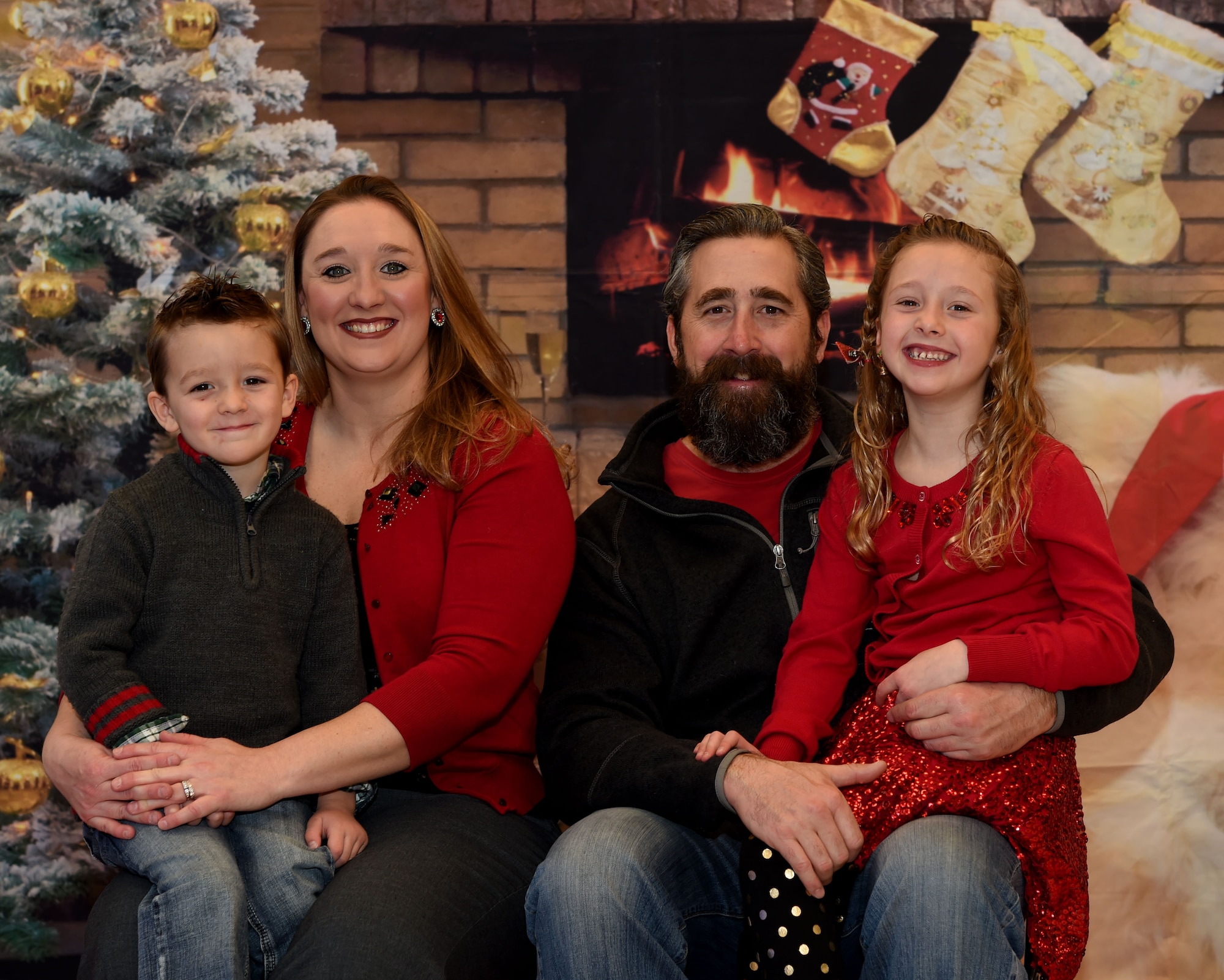 A Creech Air Force Base family poses for a photo during the first Creech Family Photo Day Dec. 19, 2015, in Las Vegas, Nevada. The photo day provided an opportunity for Creech members to bring their families and pets to a location where they could receive free family photos for the holidays. (U.S. Air Force photo by Tech. Sgt. Nadine Barclay)