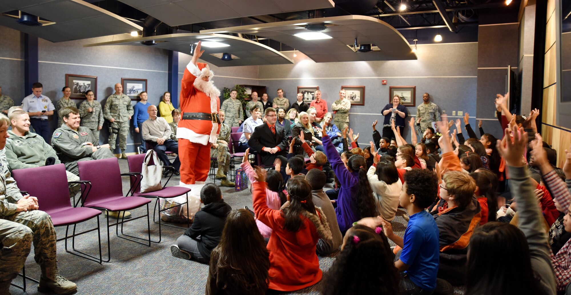Sutton Elementary fourth grader students are greeted by Santa Claus Dec. 15, 2015 during a visit to the base through the Partners in Education program. The Partners in Education program links the wing with an area school allowing them to tap into the expertise of the unit members when help or mentoring is needed. The 188th has teamed up with Sutton for more than 20 years to mentor children, build the program and reach out to the community. (U.S. Air National Guard photo by Staff Sgt. Hannah Dickerson/Released)