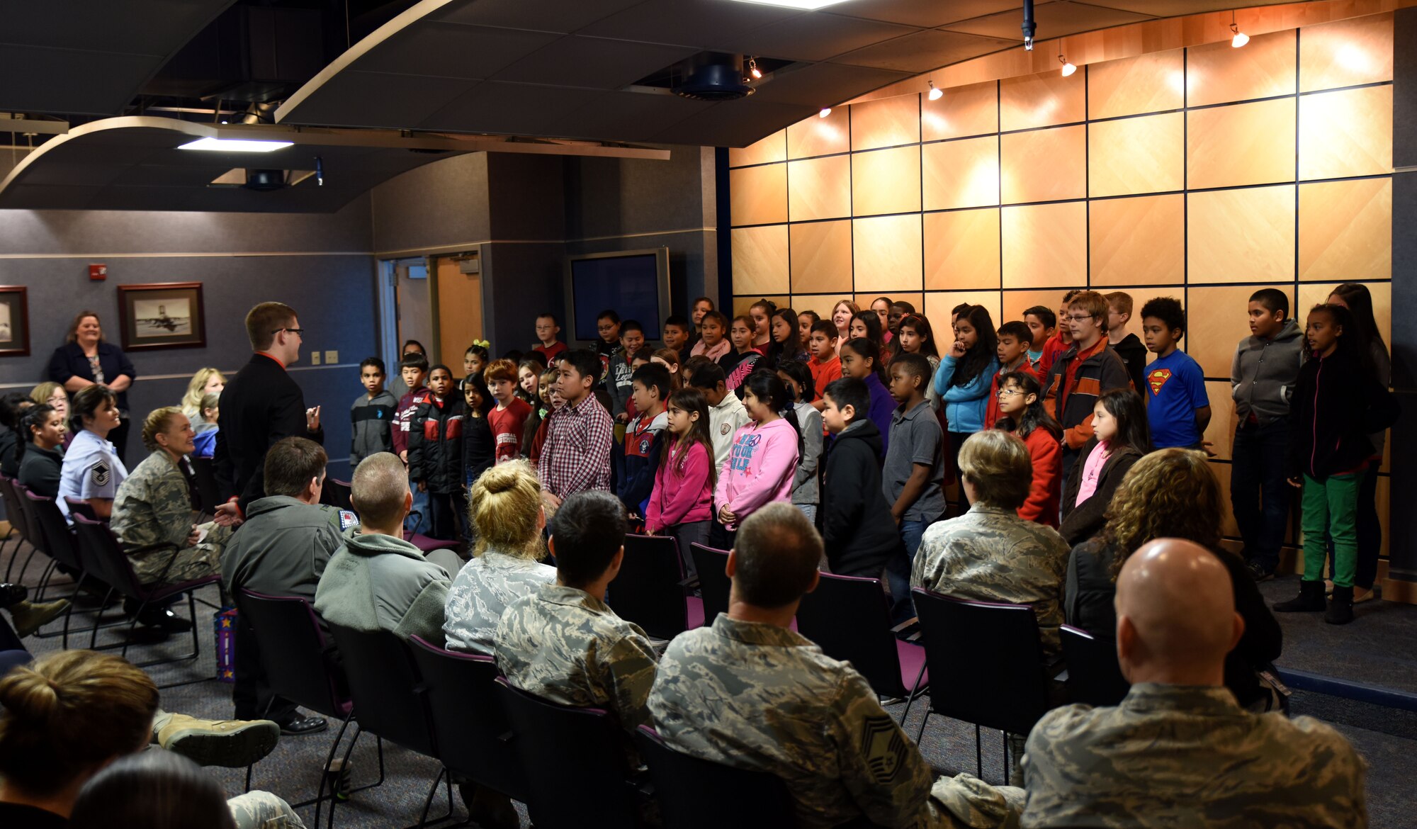 Students from Sutton Elementary sing Christmas carols to members of the 188th Wing Dec. 15, 2015 as a part of the Partners in Education program. The 188th has teamed up with Sutton for more than 20 years to mentor children, build the Partners in Education program and reach out to the community. The Partners in Education program links the wing with an area school allowing them to tap into the expertise of the unit members when help or mentoring is needed.  (U.S. Air National Guard photo by Staff Sgt. Hannah Dickerson/Released)