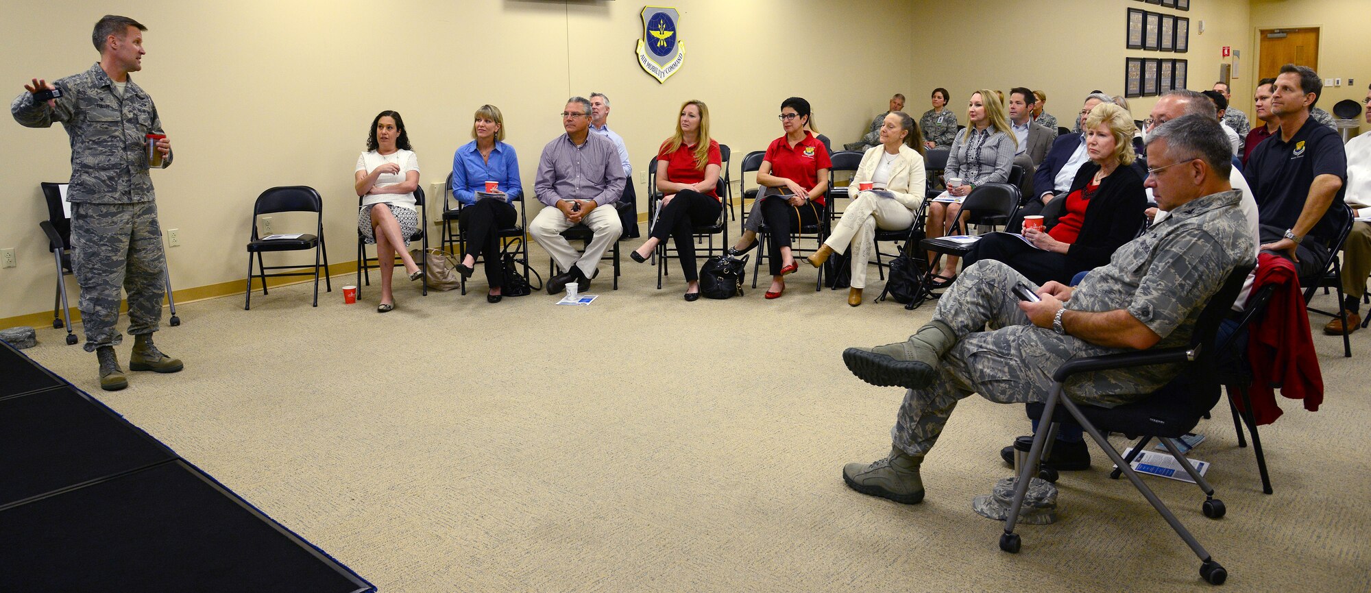 Col. Daniel Tulley, commander of the 6th Air Mobility Wing, gives the Wing Mission Brief to a group of honorary commanders during an immersion at the 6th Medical Group at MacDill Air Force Base, Fla., Dec. 18, 2015. This immersion was the first of the quarterly immersions for the newly appointed honorary commanders of the 6th AMW and the 927th Air Refueling Wing. (U.S. Air Force photo by Staff Sgt. Brittany Liddon)