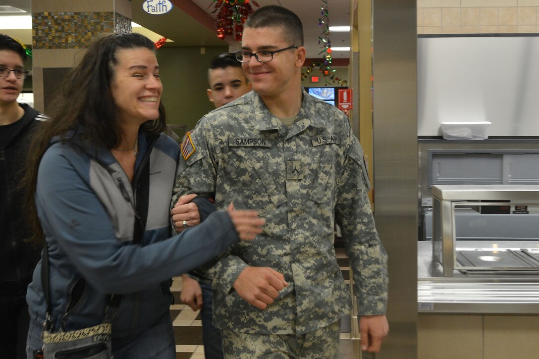 U.S. Army Pvt. Clint Sampson, a student  assigned to the 128th Aviation Brigade Advanced Individual Training, meets with his family during the Brigade’s exodus at Fort Eustis, Va., Dec. 18, 2015. The exodus marks the students’ first opportunity to take leave in the military. (U.S. Air Force photo by Staff Sgt. Natasha Stannard)