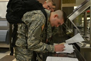 U.S. Army Pvt. Timothy Makara, a student with the 128th Aviation Brigade Advanced Individual Training, who is from Poughkeepsie, N.Y., signs out for exodus at Fort Eustis, Va., Dec. 18, 2015. The students and staff of the 128th Aviation Brigade’s schools were allotted a break  from instruction to take leave during the holidays. (U.S. Air Force photo by Staff Sgt. Natasha Stannard)