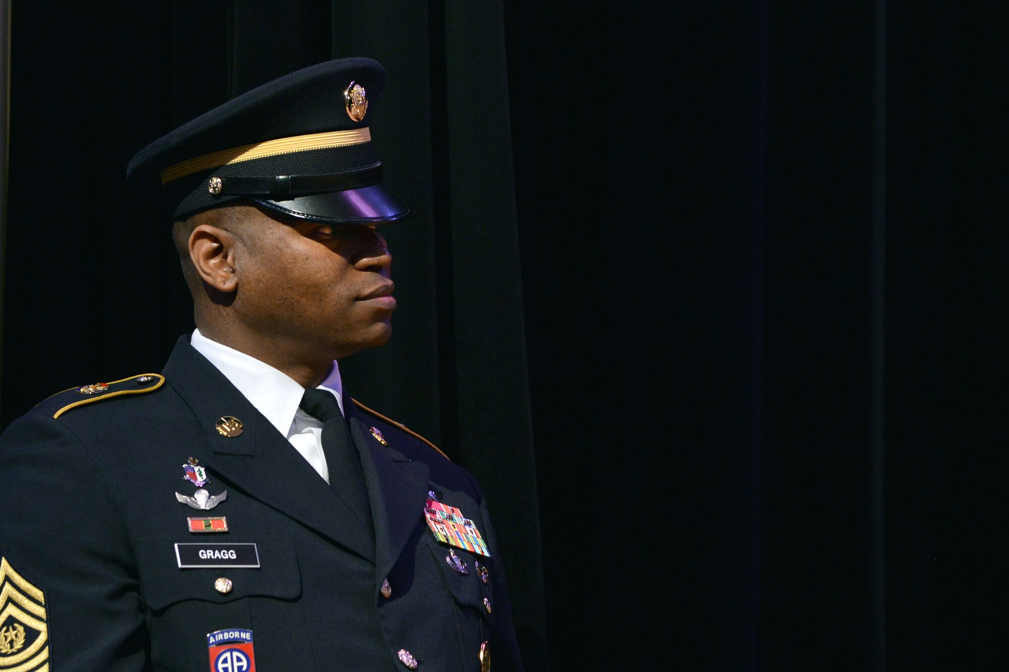 U.S. Army Command Sgt. Maj. Michael L. Gragg, command sergeant major of U.S. Army Training and Doctrine Command Center for Initial Military Training (CIMT), listens as Maj.  Gen. Anthony C. Funkhouser, commander of CIMT, speaks during the CIMT change of responsibility at Fort Eustis, Va., Dec. 16, 2015. Gragg enlisted in the Army as a combat medic and has served for 26 years.  (U.S. Air Force photo by Staff Sgt. Natasha Stannard)