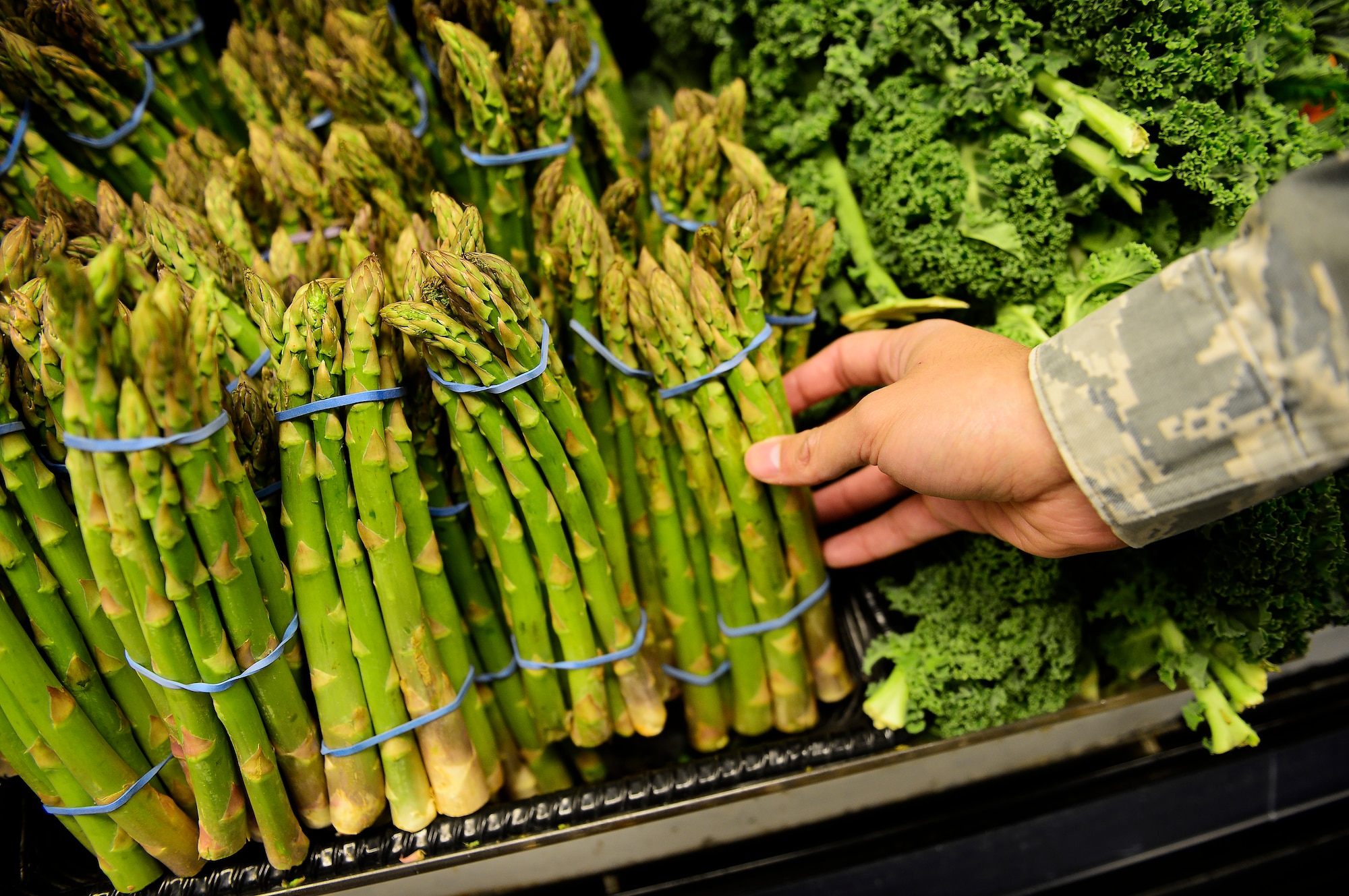 Airmen shop for fresh produce at the commissary at Royal Air Force Lakenheath, England, Dec. 7, 2015. The produce sold at the commissary is the same produce provided to the Royal Family. (U.S. Air Force photo by Airman 1st Class Erin R. Babis/Released)
