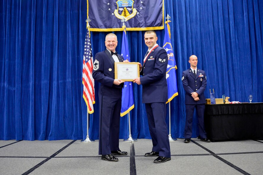 MCGHEE TYSON AIR NATIONAL GUARD BASE, Tenn. -  Senior Airman Zachary Hallstrom, right, receives the Distinguished Graduate Award for Airman leadership school class 16-2 from Chief Master Sgt. Kevin Thomas, Air National Guard advisor to the commander, Thomas N. Barnes Center for Enlisted Education, here, Dec. 17, 2015, at the I. G. Brown Training and Education Center. The distinguished graduate award is presented to students in the top 10 percent of the class.(U.S. Air National Guard photo by Master Sgt. Jerry D. Harlan/Released)