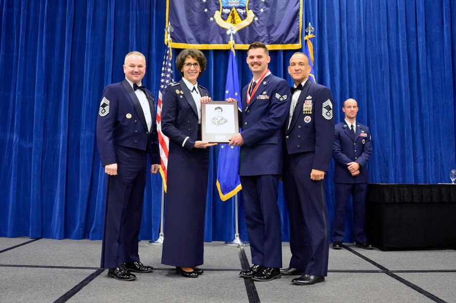MCGHEE TYSON AIR NATIONAL GUARD BASE, Tenn. -  Senior Airman Kyle James, receives the John L. Levitow honor for Airman leadership school class 16-2 from Chief Master Sgt. Kevin Thomas, Air National Guard advisor to the commander, Thomas N. Barnes Center for Enlisted Education,  Col. Jessica Meyeraan, commander of the I.G. Brown Training and Education Center and Chief Master Sgt. Edward L. Walden, Sr., commandant of the Paul H. Lankford Enlisted PME Center, here, Dec. 17, 2015, at the TEC. (U.S. Air National Guard photo by Master Sgt. Jerry D. Harlan/Released)
