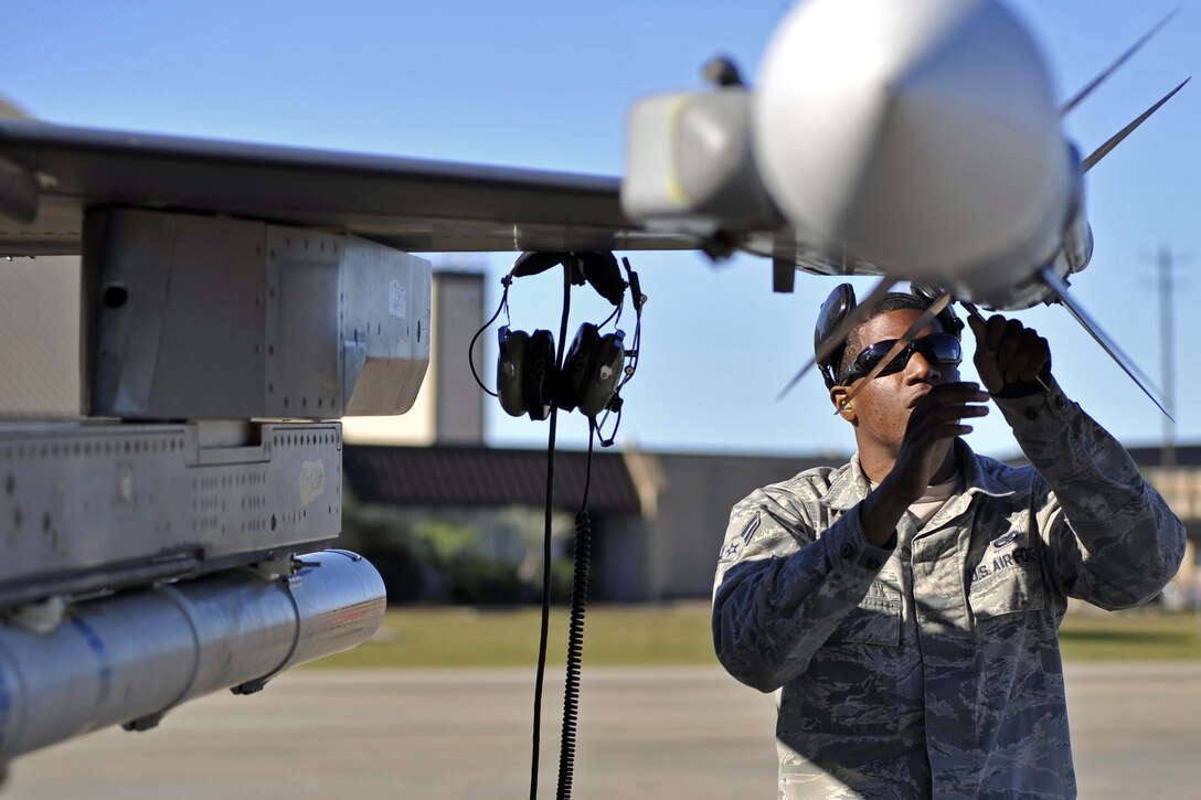 An airman performs maintenance on a training missile on Tyndall Air Force Base, Fla., Dec. 15, 2015. The airman is an aircraft armament member assigned to the 20th Aircraft Maintenance Squadron and deployed from Shaw Air Force Base, S.C. Airmen from Shaw came to Tyndall for the 53rd Weapons Evaluation Group’s weapons system evaluation program and the Checkered Flag 16-1 exercise. U.S. Air Force photo by Senior Airman Sergio A. Gamboa