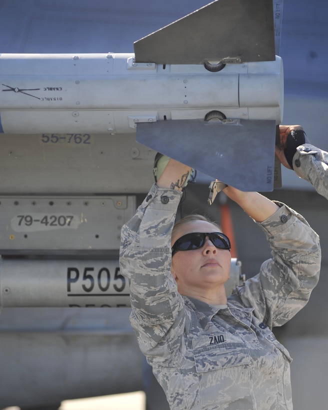 An airman checks an F-16 Fighting Falcon aircraft missile on Tyndall Air Force Base, Fla., Dec. 15, 2015. The airman is an aircraft armament member assigned to the 20th Aircraft Maintenance Squadron. U.S. Air Force photo by Senior Airman Sergio A. Gamboa