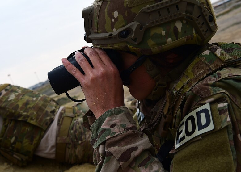 Staff Sgt. Ashley Ingalls, 407th Air Expeditionary Wing Explosive Ordnance Disposal technician, watches as a member of her team conducts a manual sweep of an area in search of explosives during a joint EOD training exercise at an undisclosed location in Southwest Asia, Dec. 15, 2015. The five-day exercise included common scenarios experienced in the field as well as training at the EOD range using real explosives. (U.S. Air Force photo by Staff Sgt. Jerilyn Quintanilla)