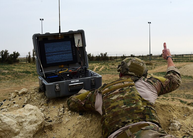 Senior Airman Christian Hulsey, a 386th Explosive Ordnance Disposal technician, signals his teammate during a joint EOD training exercise at an undisclosed location in Southwest Asia, Dec. 15 2015. Hulsey and his team simulated an explosives sweep using a Mark 2 Talon robot. (U.S. Air Force photo by Staff Sgt. Jerilyn Quintanilla)