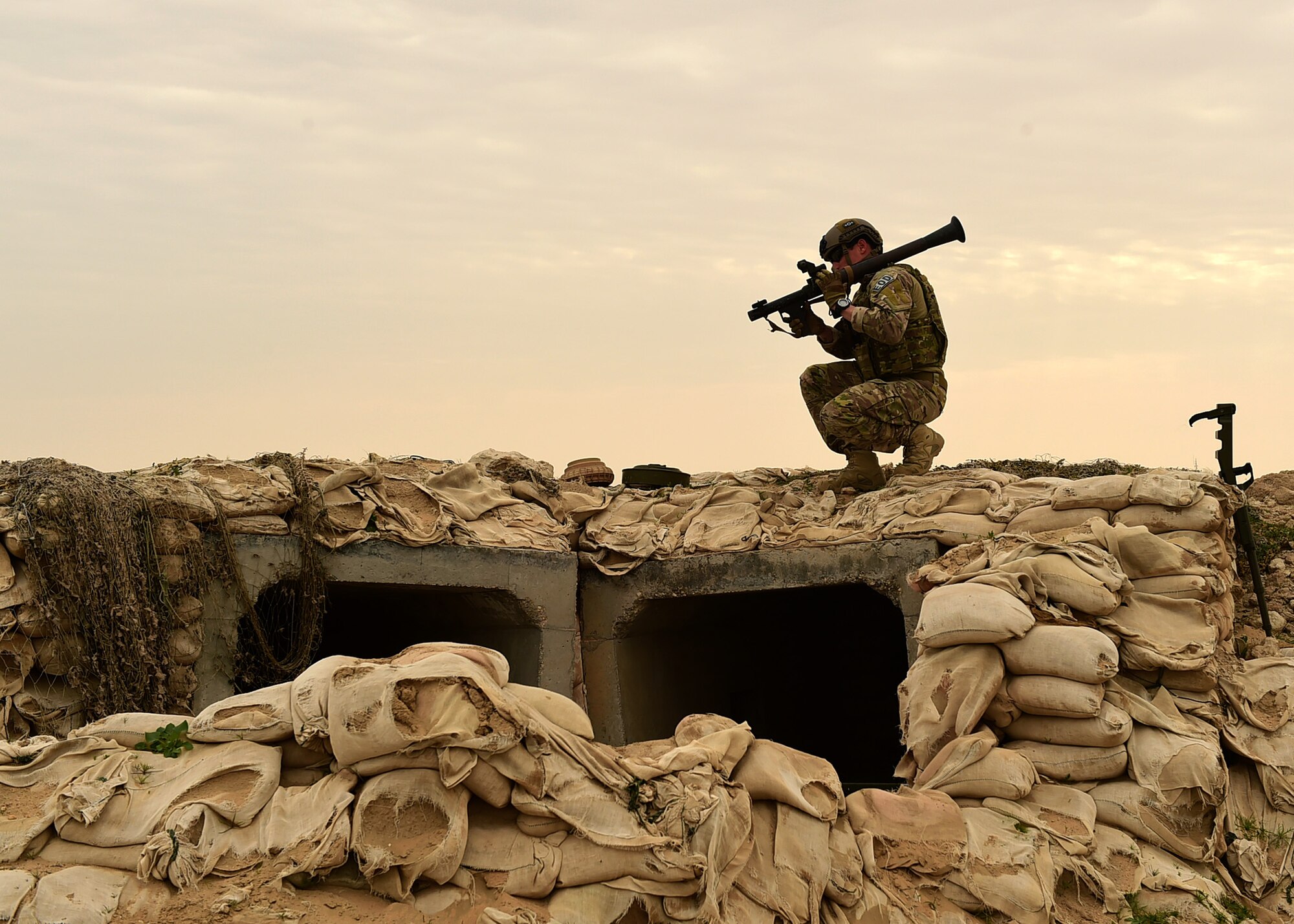 Staff Sgt. Andrew Croop, a 386th Air Expeditionary Wing explosive ordnance disposal technician, picks up a simulated rocket launcher during a joint EOD training exercise at an undisclosed location in Southwest Asia, Dec. 15, 2015. As part of the exercise, Croop conducted a manual sweep of a suspicious area in search of ordnances and secured the area. (U.S. Air Force photo by Staff Sgt. Jerilyn Quintanilla)
