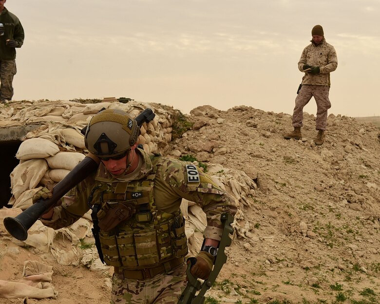 Marine Gunnery Sgt. Brian Murphy, EOD team lead, takes notes of Staff Sgt. Andrew Croop’s, a 386th Air Expeditionary Wing explosive ordnance disposal technician, performance during a joint EOD training exercise at an undisclosed location in Southwest Asia, Dec. 15, 2015. Air Force, Marine and Army EOD technicians came together for the first time here to conduct a five-day training event comprised of more than 40 scenarios. (U.S. Air Force photo by Staff Sgt. Jerilyn Quintanilla) 