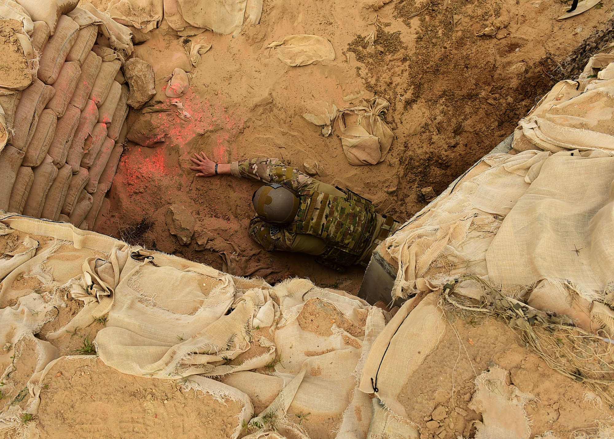 Staff Sgt. Andrew Croop, a 386th Air Expeditionary Wing explosive ordnance disposal technician, conducts a finger sweep for ordnances during a joint EOD training exercise at an undisclosed location in Southwest Asia, Dec. 15, 2015. The 386th EOD flight hosted Marine and Army EOD techs for the exercise as a way to learn from each other’s experiences and the different service’s methods. (U.S. Air Force photo by Staff Sgt. Jerilyn Quintanilla)