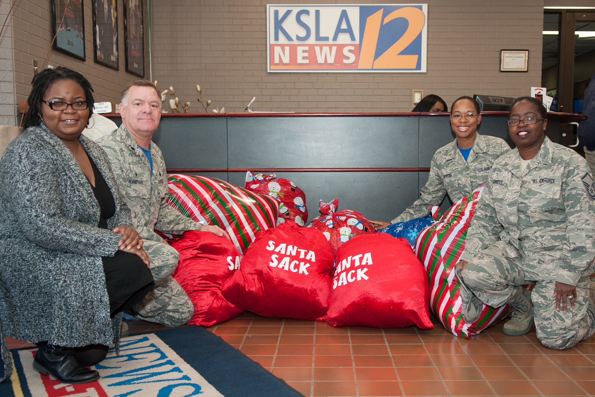 The 307th Maintenance Group donates bags filled with 91 coats for the local KSLA News 12 Porter’s Cleaners Coats for Kids drive in Shreveport, La. on Dec. 18, 2015. These coats will be going to children in the local area that would otherwise be without. (U.S. Air Force photo by Master Sgt. Dachelle Melville/Released)