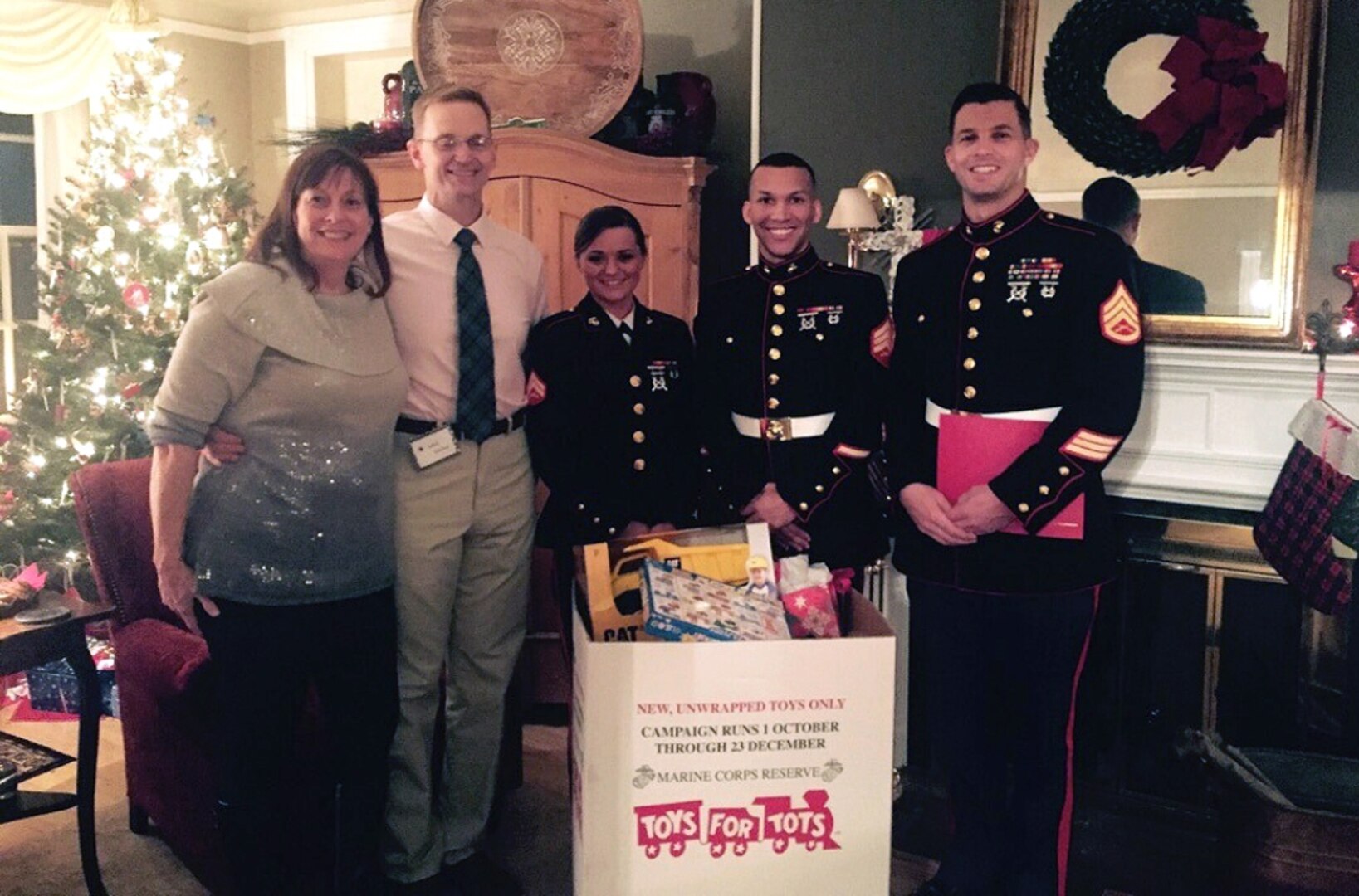 Toys for Tots donations are collected by, from left to right, Laura McLeod, Air Force Brig. Gen. Mark McLeod, Marine Cpl. Chelsea Propes, Marine Sgt. Robert Bradley and Marine Staff Sgt. Andrew Eichelberger. Defense Logistics Agency Energy employees contributed more than 150 toys during the DLA Energy commander’s holiday reception at Fort Belvoir, Virginia, Dec. 19. Photo by Army Capt. Keith De Silva