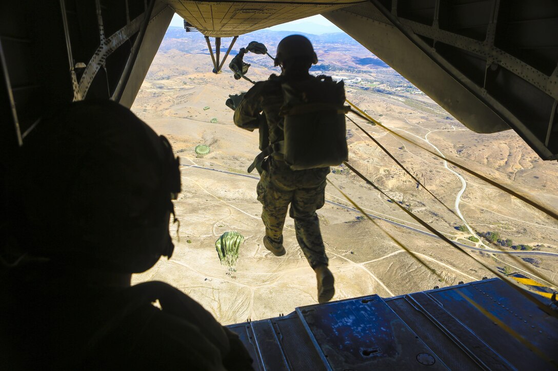 Marines with 1st Expeditionary Operations Training Group parachute via static line at 1,500 feet above Drop Zone Basilone, Marine Corps Base Camp Pendleton, Calif., Dec. 21. Marine Heavy Helicopter Squadron (HMH) 462 supported the 1st EOTG in their parachute-operations training. This training is intended to improve the Marines’ skill for future uses of this knowledge, such as a deployment situation. Units like the 1st EOTG deploy often and this training allows the Marines to be ready to deploy at a moment’s notice.(U.S. Marine Corps photo by Lance Cpl. Harley Robinson/Released)