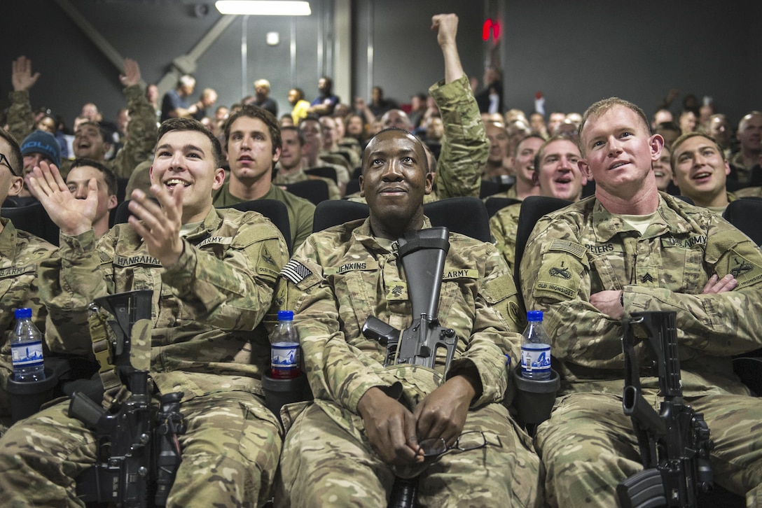 U.S. service members cheer as they prepare to view the first showing of "Star Wars: The Force Awakens" on Bagram Airfield, Afghanistan, Dec. 22, 2015. The Army and Air Force Exchange Service partnered with Walt Disney Studios to give troops a chance to see the movie from a deployed location. U.S. Air Force photo by Tech. Sgt. Robert Cloys