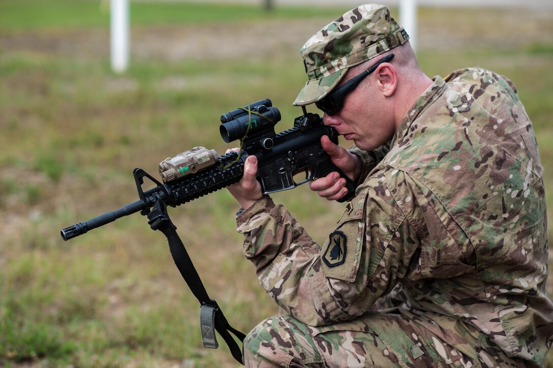 Capt. Kirk Freeman with the 98th Training Division and a member of the U.S. Army Reserve Marksmanship Team checks the zero of his Close Combat Optics during the first day of the U.S. Army Forces Command Weapons Marksmanship Competition Sept. 21, 2015, at Fort Bragg, N.C. The three-day FORSCOM competition features 27 marksmen from the U.S. Army, U.S. Army Reserve, and the National Guard in events for the M9 pistol, the M4A1 rifle, and the M249 SAW, or Squad Automatic Weapon, to recognize Soldiers who are beyond expert marksmen. The multi-tiered events challenge the competitors' ability to accurately and quickly engage targets in a variety of conditions and environments. (U.S. Army photo by Timothy L. Hale/Released)