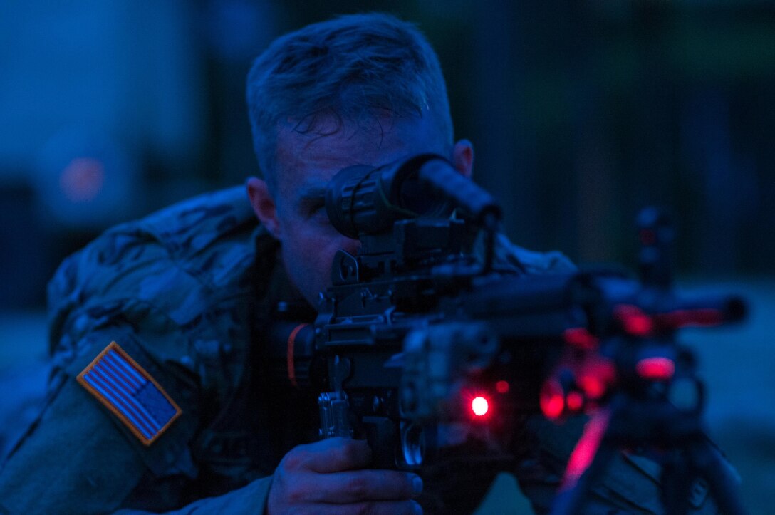 Sgt. Ben Mercer with the 416th Theater Engineer Command and a member of the U.S. Army Reserve Marksmanship team sights his M249 Squad Automatic Weapon, or SAW, before a night-fire event during the first day of the U.S. Army Forces Command Weapons Marksmanship Competition Sept. 21, 2015, at Fort Bragg, N.C. The three-day FORSCOM competition features 27 marksmen from the U.S. Army, U.S. Army Reserve, and the National Guard in events for the M9 pistol, the M4A1 rifle, and the M249, to recognize Soldiers who are beyond expert marksmen. The multi-tiered events challenge the competitors' ability to accurately and quickly engage targets in a variety of conditions and environments. (U.S. Army photo by Timothy L. Hale/Released)