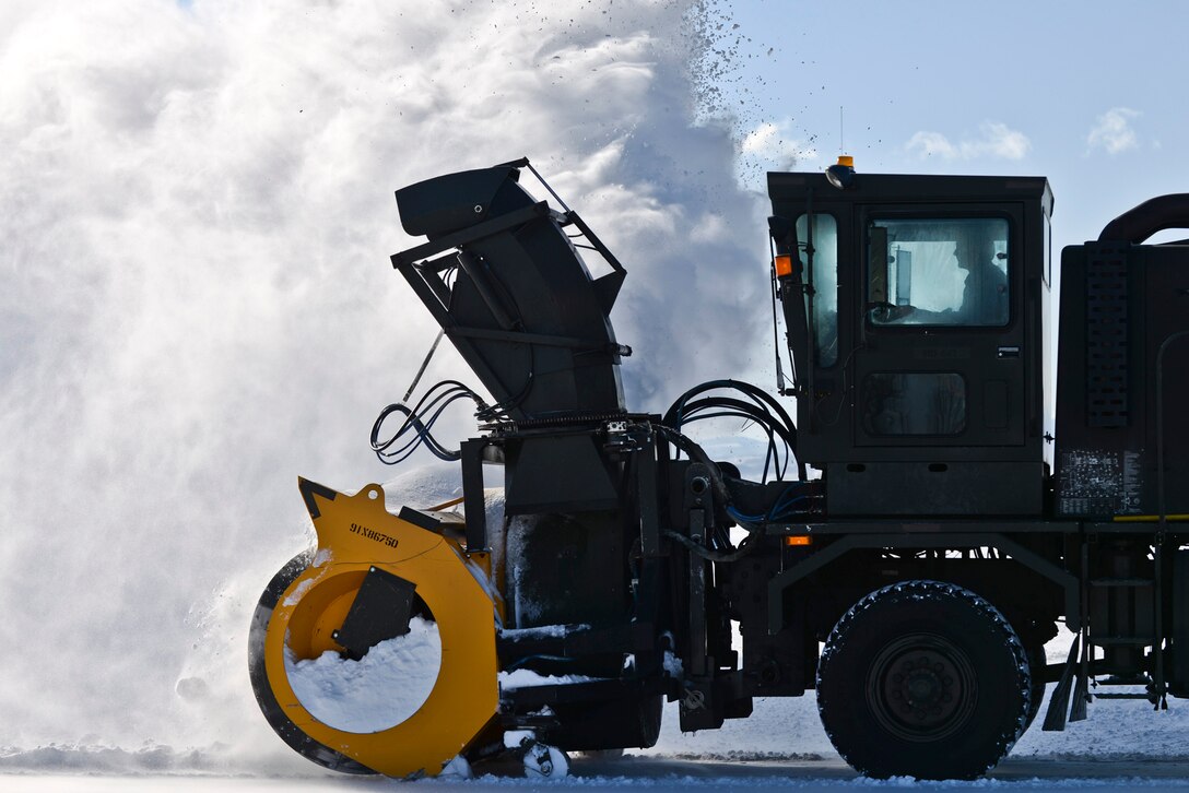 A member of  the 28th Civil Engineer Squadron operates a snowblower to clear the flightline on Ellsworth Air Force Base, S.D., Dec. 16, 2015. U.S. Air Force photo by Airman Sadie Colber