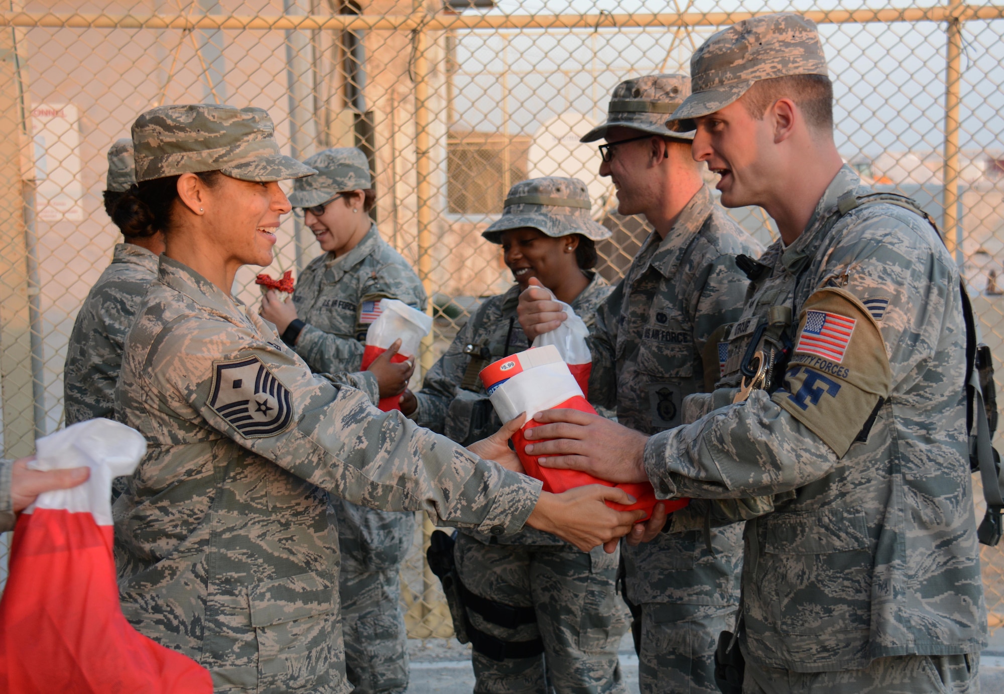 Master Sgt. Daira Hall, 379th Air Expeditionary Wing first sergeant from Minneapolis, Minnesota, delivers holiday stockings filled with candy, games and Christmas cards to security forces airmen at Al Udeid Air Base, Qatar Dec. 23. Hall said the first sergeants decided to deliver the stockings to security forces Airmen to thank them for all they do to keep people safe. (U.S. Air Force photo by Tech. Sgt. James Hodgman) 