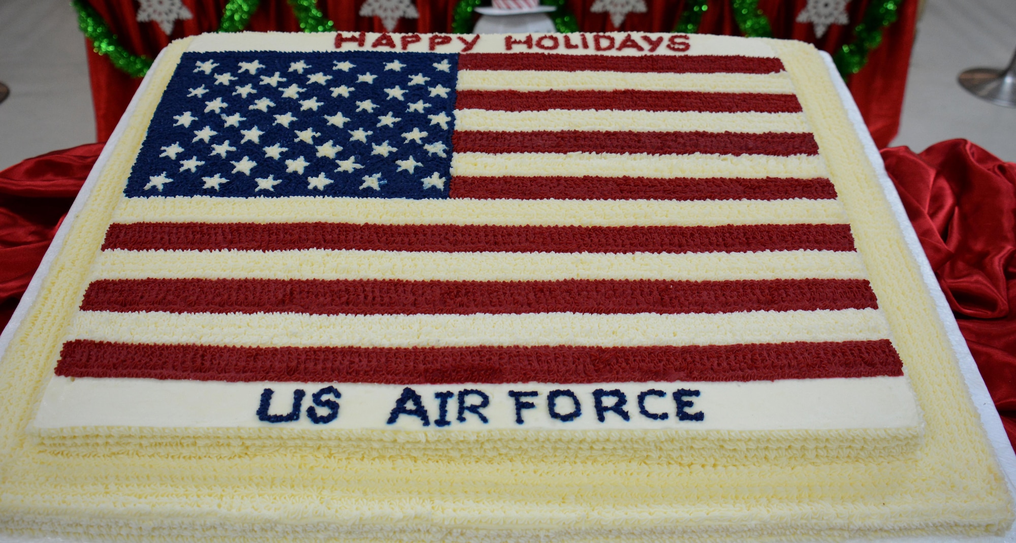 A cake decorated with the American flag is displayed inside the Independence Dining Facility at Al Udeid Air Base, Qatar Dec. 25. The cake was one of three offered for desert to the hundreds of service members who attended the holiday lunch on Christmas day. The holiday menu included lobster, turkey and a variety of deserts including pie and ice cream. (U.S. Air Force photo by Tech. Sgt. James Hodgman/Released)