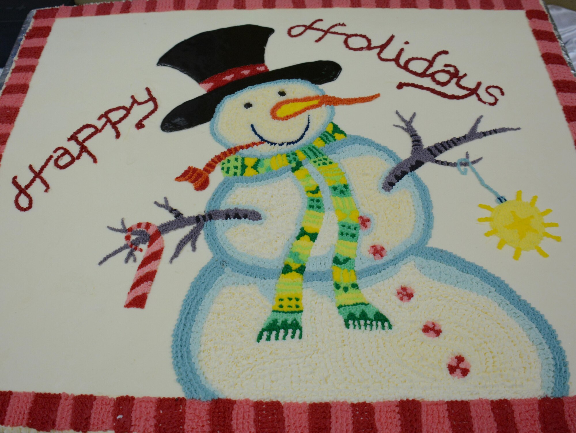 A cake decorated with a snowman is displayed inside the Independence Dining Facility at Al Udeid Air Base, Qatar Dec. 25. The cake was one of three offered for desert to the hundreds of service members who attended the holiday lunch on Christmas day. The holiday menu included lobster, turkey and a variety of deserts including pie and ice cream. (U.S. Air Force photo by Tech. Sgt. James Hodgman/Released)
