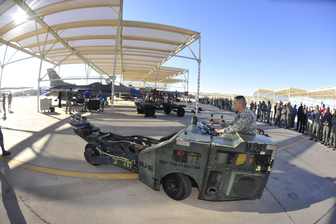 U.S. airman 1st Class Levi Ayott prepares to load an F-35 Lightning ll aircraft during the 4th quarter weapons loading competition on Luke Air Force Base, Ariz., Dec 18, 2015. Ayott is a weapons load crew member assigned to the 61st Aircraft Maintenance Unit. U.S. Air Force photo by Senior Airman Grace Lee