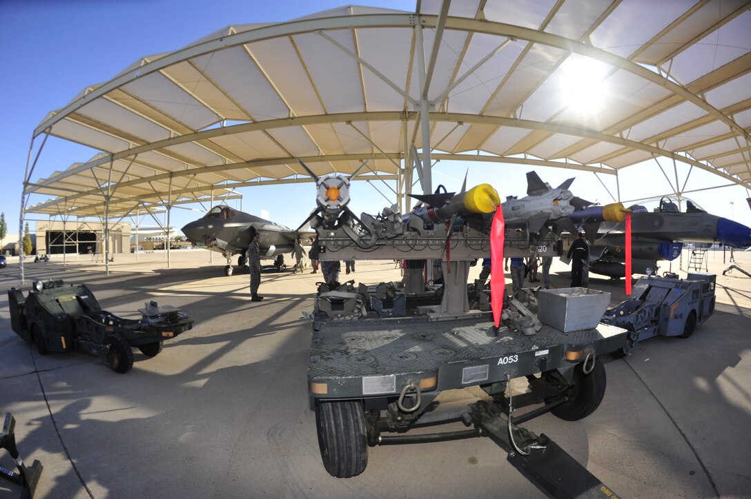 U.S. airmen compete during the 4th quarter weapons loading competition on Luke Air Force Base, Ariz., Dec 18, 2015. U.S. Air Force photo by Senior Airman Grace Lee 