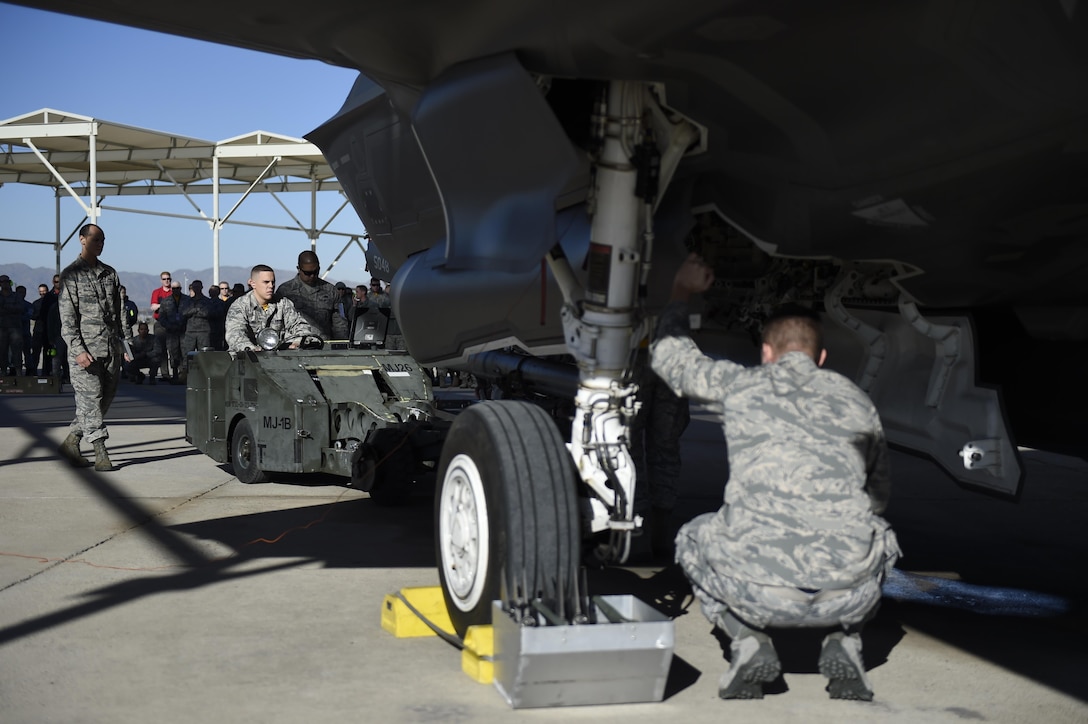 U.S. airmen prepare an F-35 Lightning ll aircraft during the 4th quarter weapons loading competition on Luke Air Force Base, Ariz., Dec 18, 2015. U.S. Air Force photo by Staff Sgt. Staci Miller