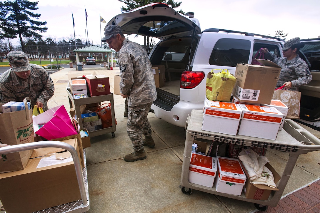 U.S. airmen unload presents for the residents of the New Jersey Veterans Memorial Home at Vineland, N.J., Dec. 16, 2015. The airmen, assigned to the New Jersey Air National Guard’s 177th Fighter Wing, were joined by 80 fourth graders from the Seaview School in Linwood, N.J., for the 15th Annual Holiday "Songfest" at the home. The airmen and fourth graders sang holiday songs to the home’s residents during the event. New Jersey Air National Guard photo by Master Sgt. Mark C. Olsen