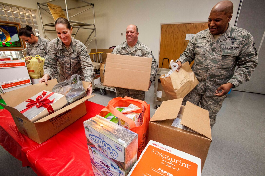 U.S. airmen prepare presents for the residents of the New Jersey Veterans Memorial Home at Vineland, N.J., Dec. 16, 2015. New Jersey Air National Guard photo by Master Sgt. Mark C. Olsen