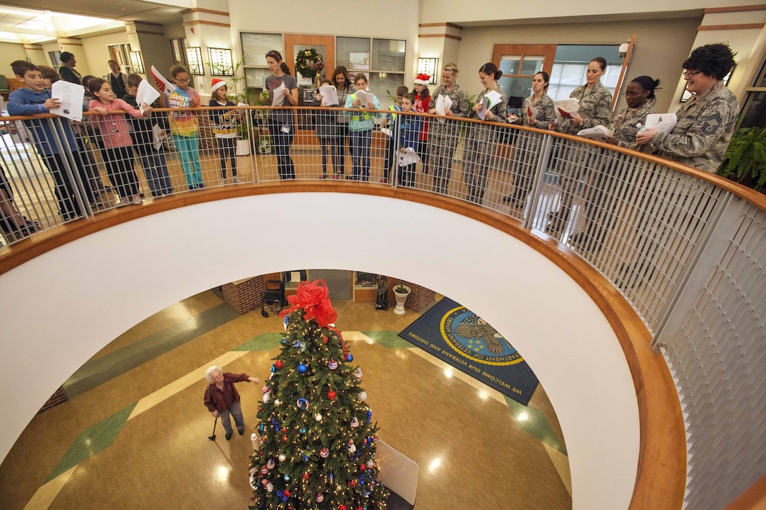U.S. airmen sing along with fourth graders from the Seaview School in Linwood, N.J., during the 15th Annual Holiday "Songfest" at the New Jersey Veterans Memorial Home at Vineland, N.J., Dec. 16, 2015. New Jersey Air National Guard photo by Master Sgt. Mark C. Olsen