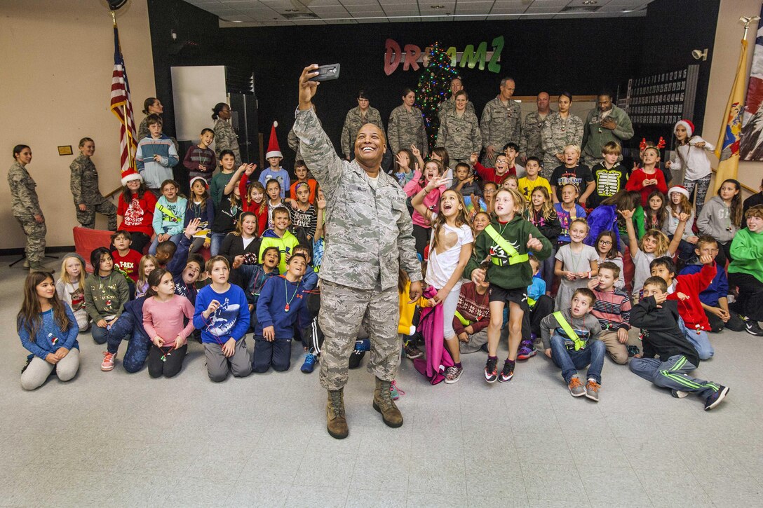 U.S. Air Force Senior Master Sgt. Harry Waugh, center, takes a selfie during the 15th Annual Holiday "Songfest" at the New Jersey Veterans Memorial Home at Vineland, N.J., Dec. 16, 2015. Waugh is assigned to the New Jersey Air National Guard’s 177th Fighter Wing. New Jersey Air National Guard photo by Master Sgt. Mark C. Olsen