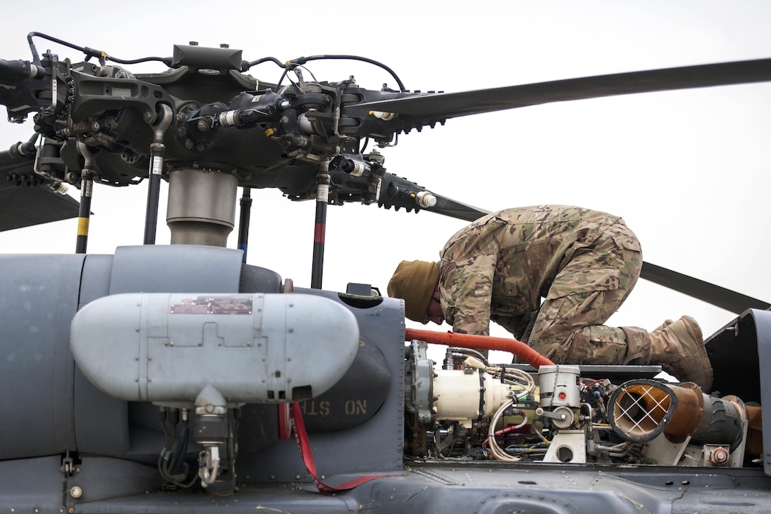 U.S. Air Force Airman 1st Class Trevor Krutsch performs preflight checks on an HH-60 Pave Hawk helicopter on Bagram Airfield, Afghanistan, Dec. 26, 2015. Krutsch, a crew chief assigned to the 455th Expeditionary Aircraft Maintenance Squadron, ensure Bagram’s combat search and rescue helicopters are ready to fly at a moment’s notice. U.S. Air Force photo by Tech. Sgt. Robert Cloys