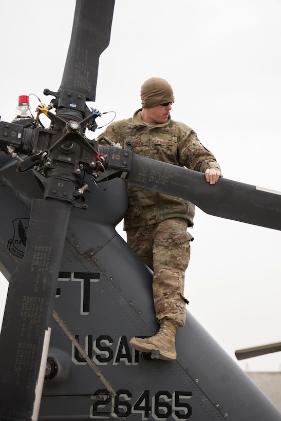 U.S. Air Force Senior Airman Donald Sweeney performs preflight checks on an HH-60 Pave Hawk helicopter on Bagram Airfield, Afghanistan, Dec. 26, 2015. Sweeney is a crew chief assigned to the 455th Expeditionary Aircraft Maintenance Squadron. U.S. Air Force photo by Tech. Sgt. Robert Cloys 